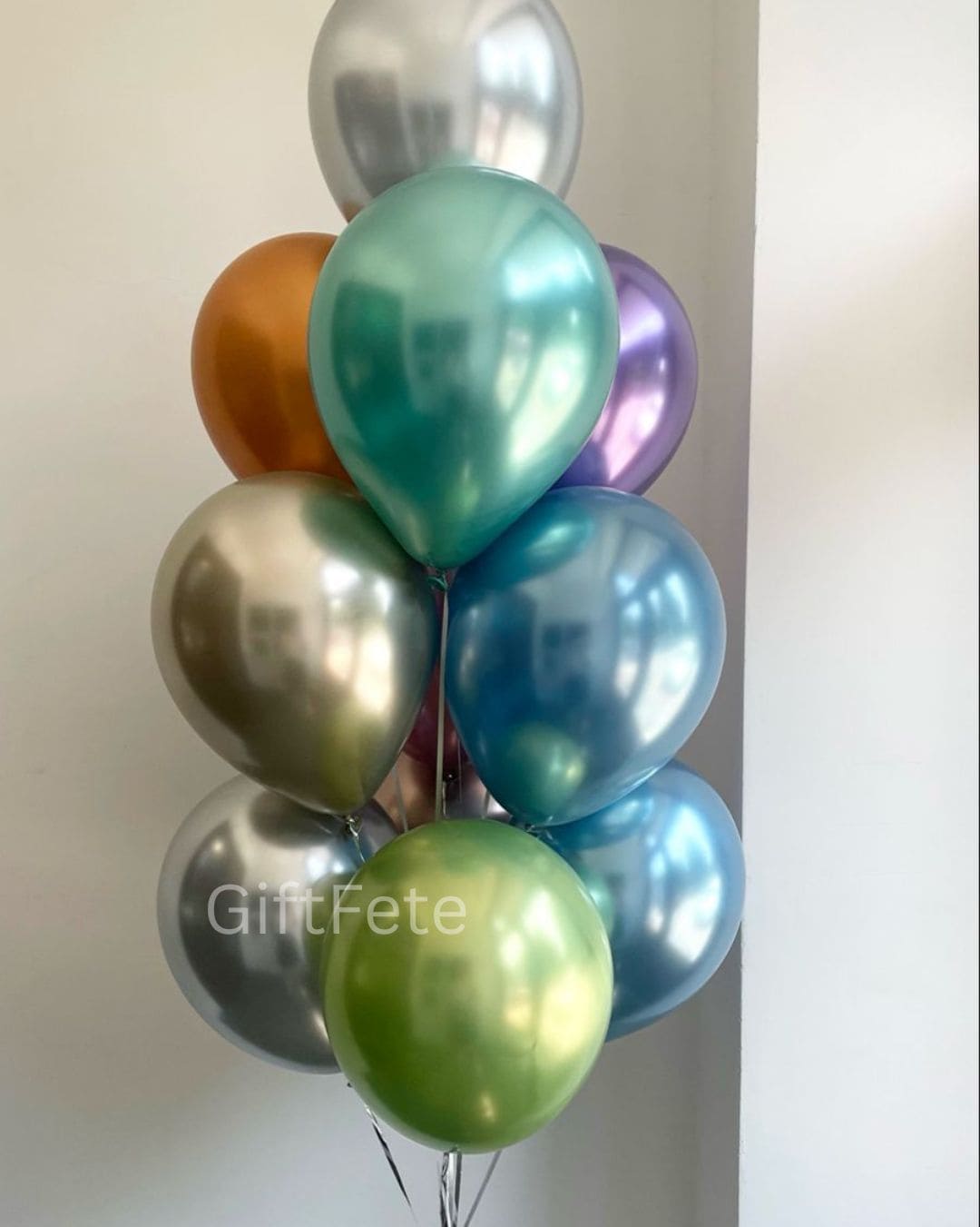 Colorful balloons arranged in a cluster against a plain background with 'GiftFete' branding.