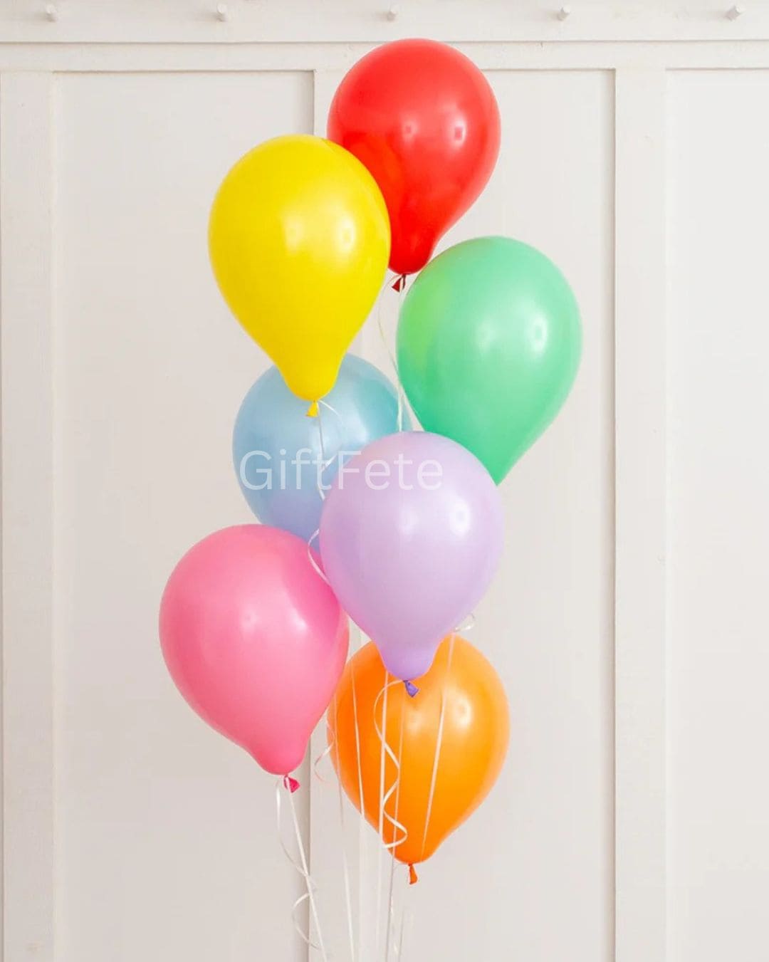 Bunch of colorful balloons against a white background with 'GiftFete' branding.